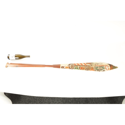 318 - A 19TH CENTURY AMERICAN TRIBAL STAINED SOFTWOOD DANCE PADDLE with painted double-sided blade. (151cm... 