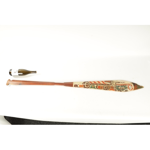 318 - A 19TH CENTURY AMERICAN TRIBAL STAINED SOFTWOOD DANCE PADDLE with painted double-sided blade. (151cm... 