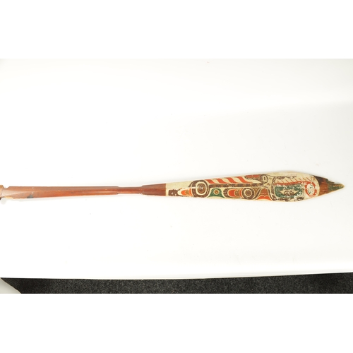 318 - A 19TH CENTURY AMERICAN TRIBAL STAINED SOFTWOOD DANCE PADDLE with painted double-sided blade. (151cm... 