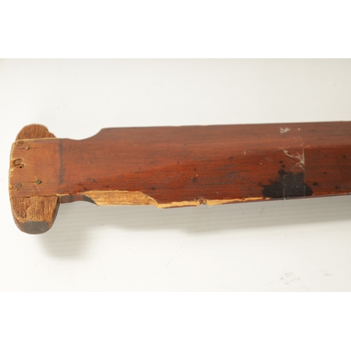 318 - A 19TH CENTURY AMERICAN TRIBAL STAINED SOFTWOOD DANCE PADDLE with painted double-sided blade. (151cm... 