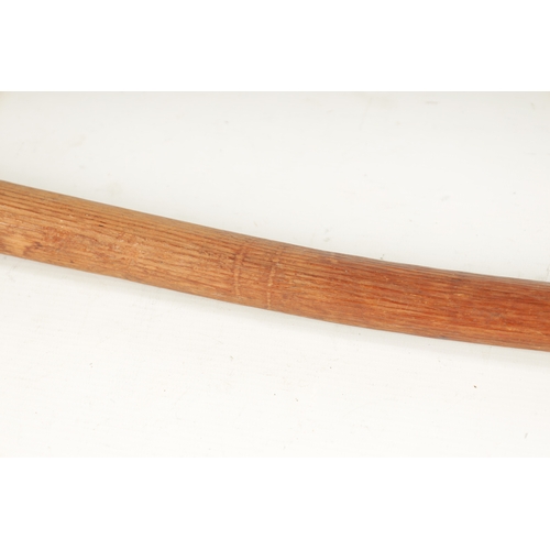 327 - AN AUSTRALIAN CURVED HARWOOD FIGHTING CLUB with grooved decorated handle (63cm overall)