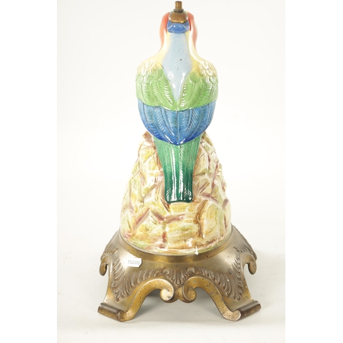 43 - AN EARLY 20TH CENTURY ROYAL DOULTON PORCELAIN AND CAST BRASS TABLE LAMP FORMED AS A PARROT the colou... 