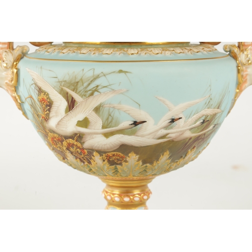 47 - C.H.C. BALDWYN A FINE ROYAL WORCESTER PEDESTAL CABINET VASE AND COVER the richly gilt and pink tinte... 