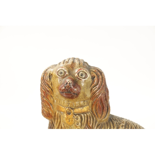 60 - A LARGE 19TH CENTURY SALT GLAZE SCULPTURE OF A SPANIEL seated on a green moulded oval base (35cm hig... 