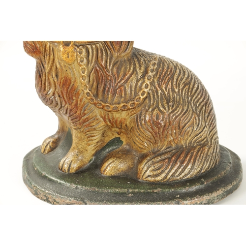 60 - A LARGE 19TH CENTURY SALT GLAZE SCULPTURE OF A SPANIEL seated on a green moulded oval base (35cm hig... 