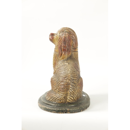 60 - A LARGE 19TH CENTURY SALT GLAZE SCULPTURE OF A SPANIEL seated on a green moulded oval base (35cm hig... 