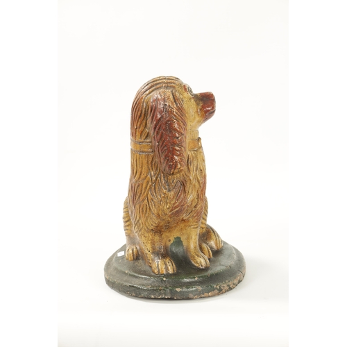 60 - A LARGE 19TH CENTURY SALT GLAZE SCULPTURE OF A SPANIEL seated on a green moulded oval base (35cm hig... 