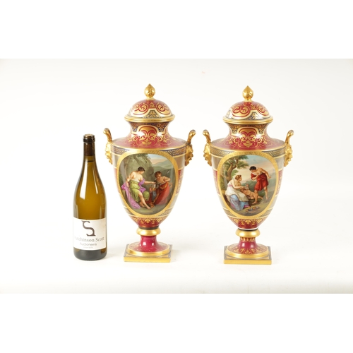 61 - A FINE PAIR OF VIENNA PORCELAIN URN SHAPED LIDDED VASES with floral gilt decoration surrounding oval... 