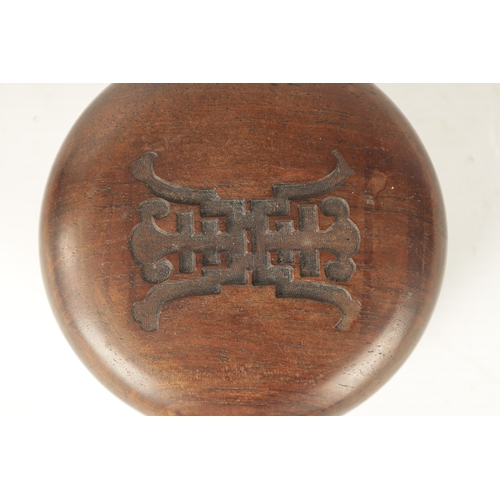 69 - A 19TH CENTURY CHINESE HUANGHUALI INK TABLET in a circular case with rounded top and carved insignia... 