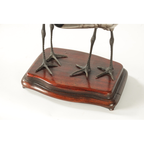 70 - A FINE JAPANESE MEIJI PERIOD SILVERED BRONZE OKIMONO OF TWO CRANES mounted on a moulded hardwood bas... 