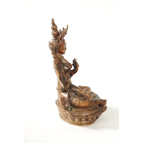 79 - A BRONZE AND JEWELLED TIBETAN BRONZE SCULPTURE modelled as a Tara Buddha with turquoise and coral ca... 