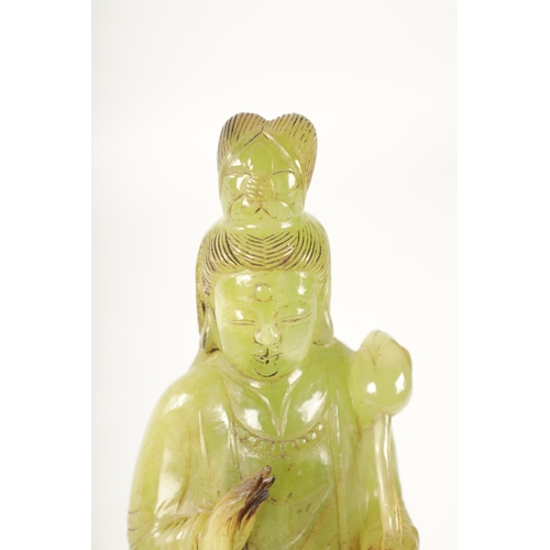 83 - A CHINESE CARVED GREEN JADE GEISHA modelled holding a lotus flower - in a fitted box (24cm high)