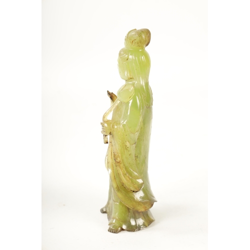 83 - A CHINESE CARVED GREEN JADE GEISHA modelled holding a lotus flower - in a fitted box (24cm high)