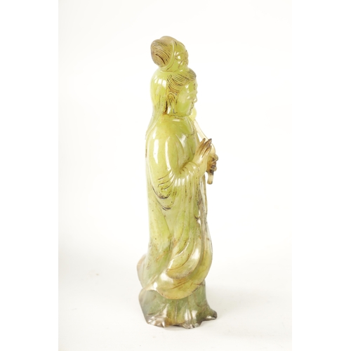 83 - A CHINESE CARVED GREEN JADE GEISHA modelled holding a lotus flower - in a fitted box (24cm high)