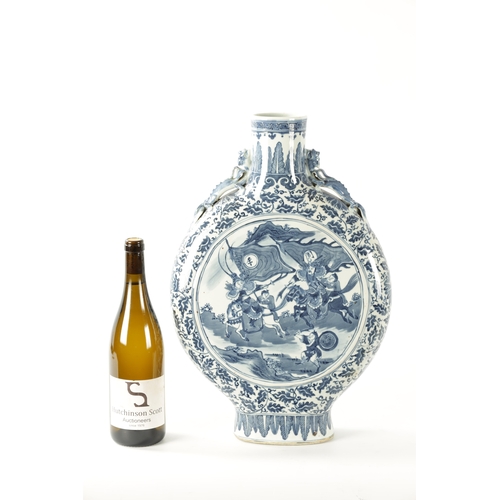 86 - A 19TH CENTURY OVER-SIZED CHINESE BLUE AND WHITE MOON FLASK with dragon handles and foliated border ... 