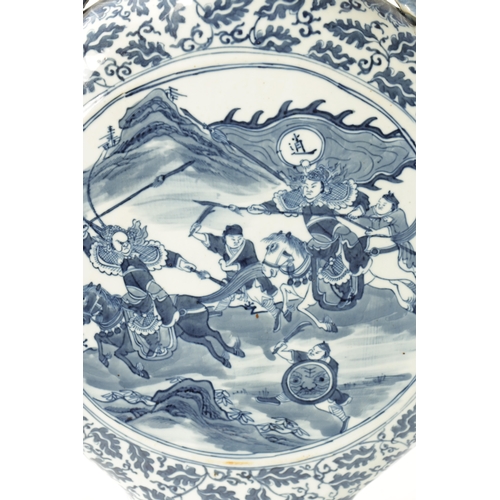 86 - A 19TH CENTURY OVER-SIZED CHINESE BLUE AND WHITE MOON FLASK with dragon handles and foliated border ... 