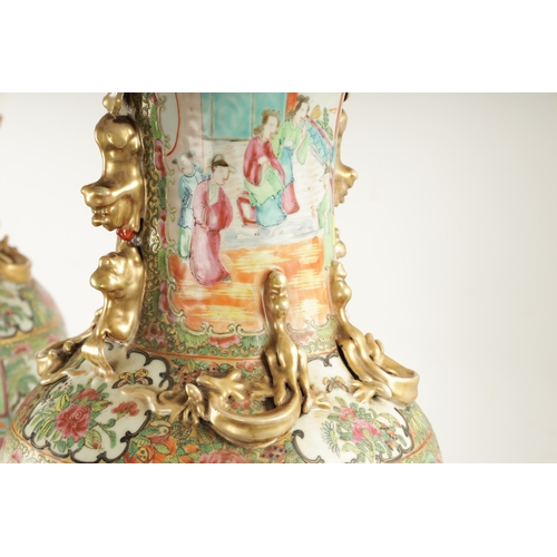 91 - A LARGE PAIR OF 19TH CENTURY CANTON FAMILLE ROSE VASES ON STANDS having panelled figural scenes and ... 