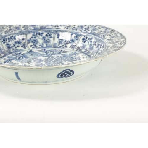 94 - A CHINESE KANGXI PERIOD BLUE AND WHITE PORCELAIN CHARGER with all over floral decoration. (34.5cm di... 