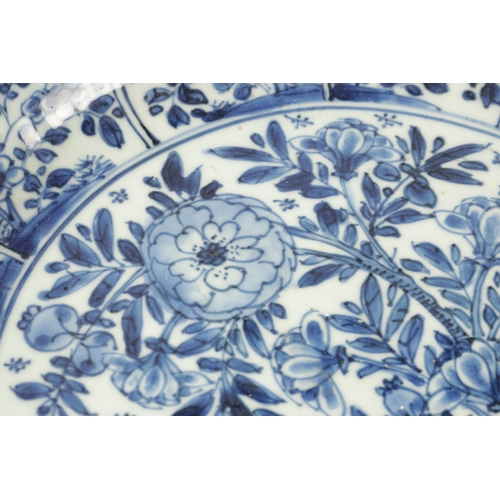 94 - A CHINESE KANGXI PERIOD BLUE AND WHITE PORCELAIN CHARGER with all over floral decoration. (34.5cm di... 