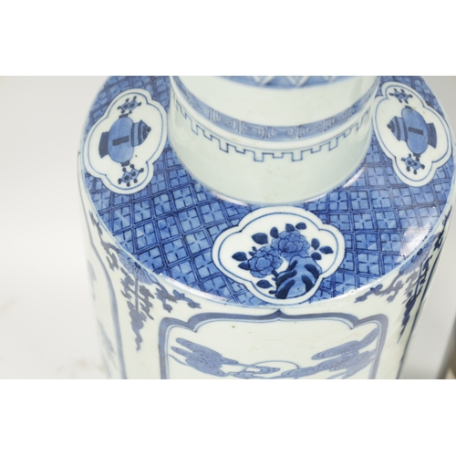 95 - A 19TH CENTURY BLUE AND WHITE CHINESE VASE the slightly tapered body with panelled decoration of flo... 