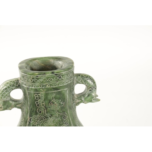 98 - A LARGE CHINESE SPINACH-GREEN JADE TWO-HANDLED VASE with a bulbous body engraved with peacocks among... 