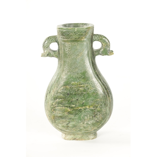 98 - A LARGE CHINESE SPINACH-GREEN JADE TWO-HANDLED VASE with a bulbous body engraved with peacocks among... 