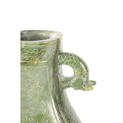 98 - A LARGE CHINESE SPINACH-GREEN JADE TWO-HANDLED VASE with a bulbous body engraved with peacocks among... 