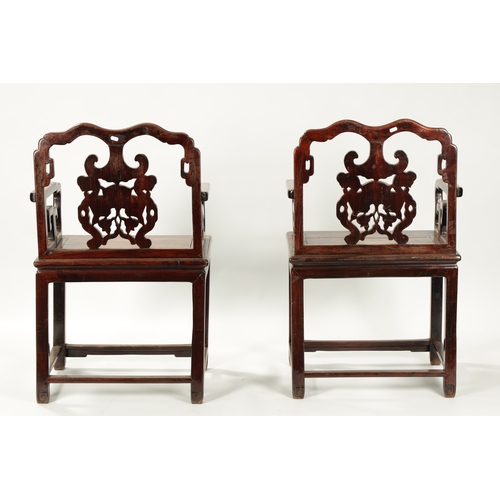 99 - A GOOD PAIR OF 19TH CENTURY CHINESE HARDWOOD OPEN ARMCHAIRS the shaped geometric backs with ornate c... 