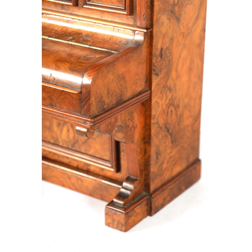 336 - A 19TH CENTURY FIGURED WALNUT CIGAR COMPENDIUM FORMED AS AN UPRIGHT PIANO decorated with marquetry p... 