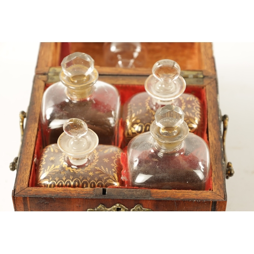 338 - AN EARLY 18TH CENTURY INLAID YEW WOOD VENEERED DECANTER BOX with hinged top revealing four gilt glas... 