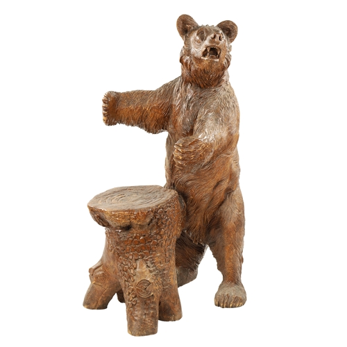 345 - A GOOD 19TH CENTURY CARVED LINDEN WOOD BLACK FOREST BEAR STOOL with standing bear in front of a stum... 