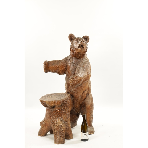 345 - A GOOD 19TH CENTURY CARVED LINDEN WOOD BLACK FOREST BEAR STOOL with standing bear in front of a stum... 