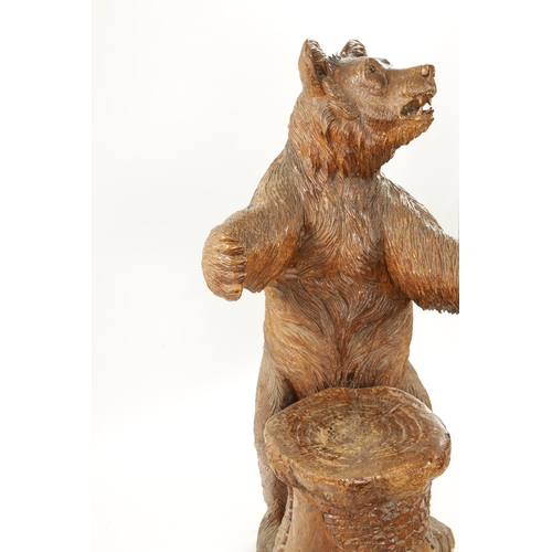 345 - A GOOD 19TH CENTURY CARVED LINDEN WOOD BLACK FOREST BEAR STOOL with standing bear in front of a stum... 