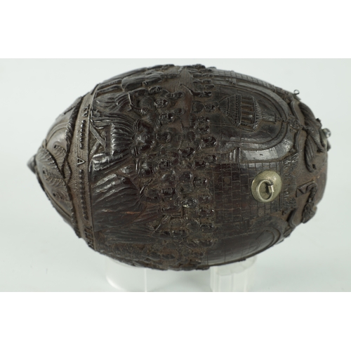 349 - A FINE 18TH CENTURY CARVED COCONUT POWDER FLASK decorated with figures in a banqueting hall, having ... 