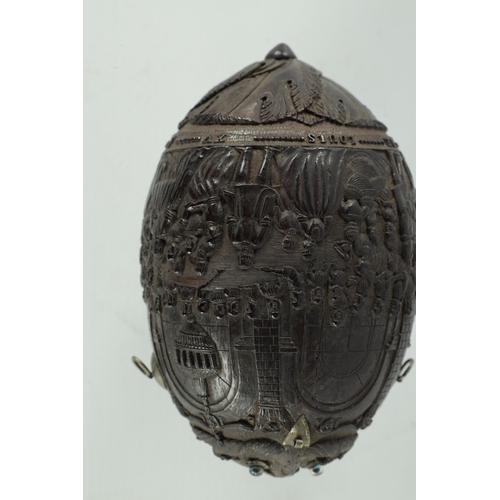 349 - A FINE 18TH CENTURY CARVED COCONUT POWDER FLASK decorated with figures in a banqueting hall, having ... 