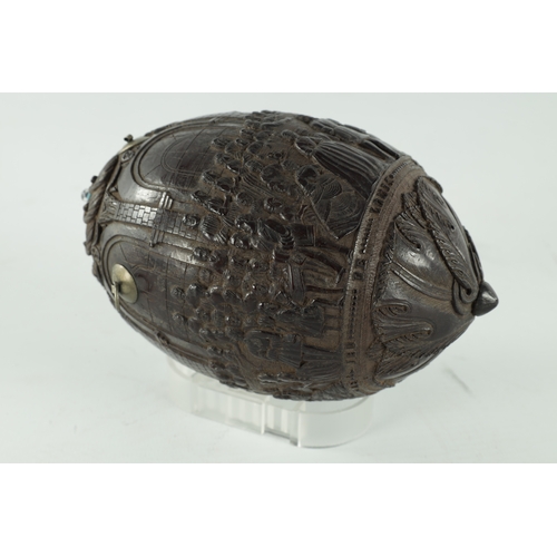 349 - A FINE 18TH CENTURY CARVED COCONUT POWDER FLASK decorated with figures in a banqueting hall, having ... 