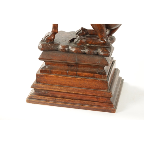 351 - A GOOD 19TH CENTURY CARVED WALNUT OVER-SIZED SCULPTURE OF A SEATED GREYHOUND on a tiered rectangular... 