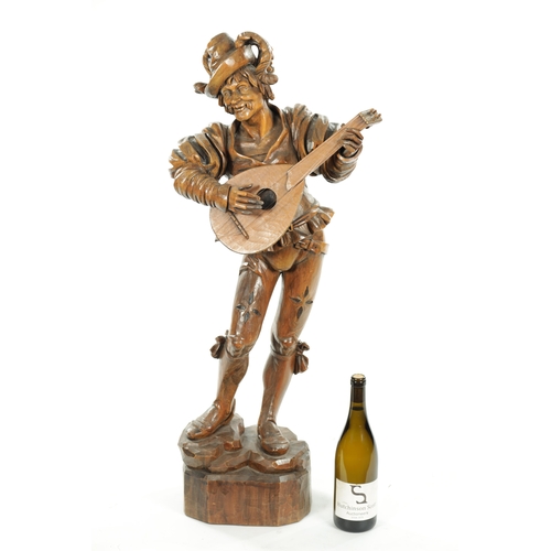 354 - A GOOD 19TH CENTURY BLACK FOREST CARVED LINDEN WOOD FIGURE OF A MUSICIAN depicting a lute player on ... 