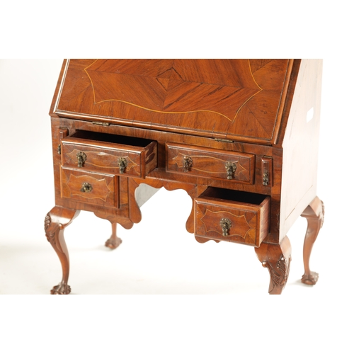 356 - A GEORGE II STYLE MINIATURE WALNUT BUREAU with boxwood strung inlays having an angled fall with smal... 