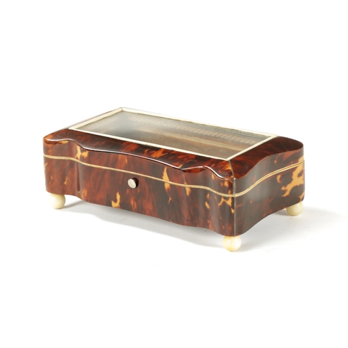 367 - A 19TH CENTURY TORTOISESHELL AND IVORY SERPENTINE GLAZED TOP DRESSING TABLE BOX with glazed hinged l... 