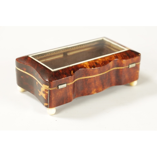 367 - A 19TH CENTURY TORTOISESHELL AND IVORY SERPENTINE GLAZED TOP DRESSING TABLE BOX with glazed hinged l... 