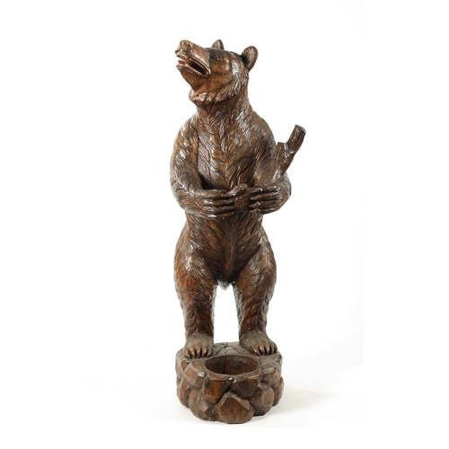 387 - A GOOD 19TH CENTURY CARVED WALNUT BLACK FOREST STANDING BEAR STICK STAND depicting a standing bear r... 