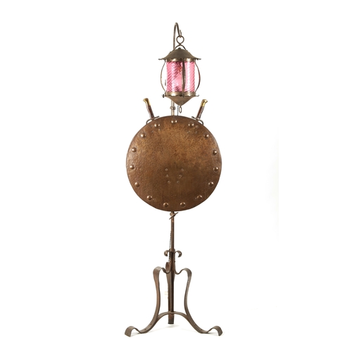 391 - A STYLISH ART AND CRAFTS PLANISHED COPPER AND STEEL ADJUSTABLE STANDARD LAMP with hanging ruby glass... 