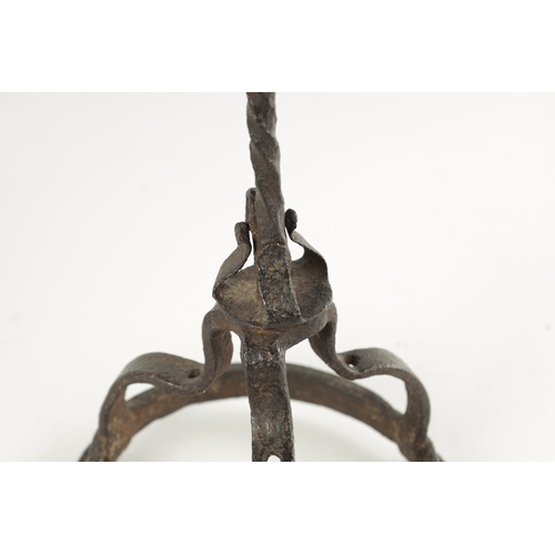 392 - A 17TH CENTURY WROUGHT IRON TALLOW STICK POSSIBLY IRISH with twisted stem and circular openwork trip... 