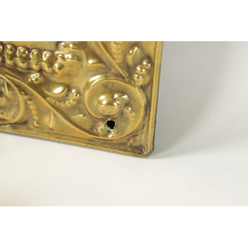 394 - AN 18TH CENTURY PRESSED BRASS WALL SCONCE with arched scrolled leafwork border and cushion centre; h... 