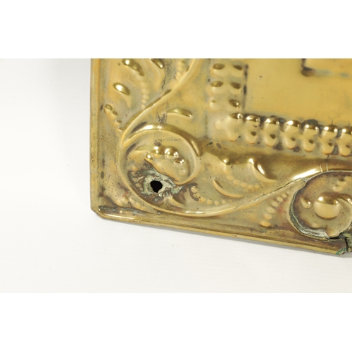 394 - AN 18TH CENTURY PRESSED BRASS WALL SCONCE with arched scrolled leafwork border and cushion centre; h... 