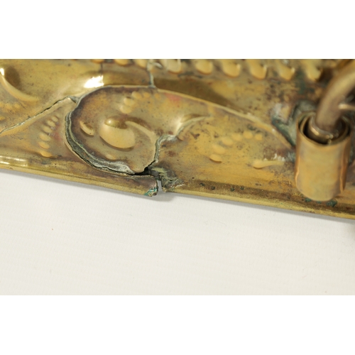 394 - AN 18TH CENTURY PRESSED BRASS WALL SCONCE with arched scrolled leafwork border and cushion centre; h... 