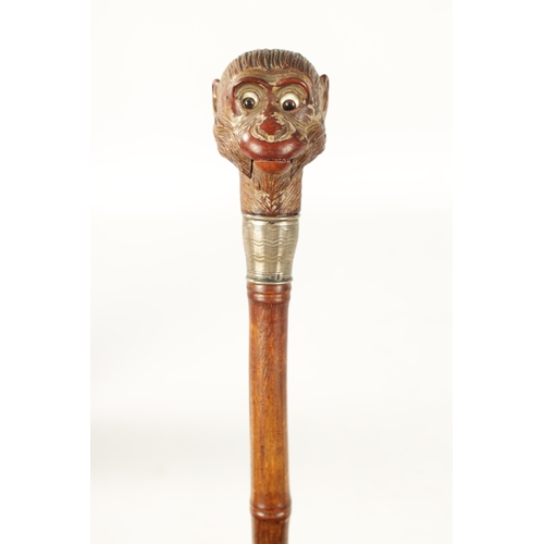 398 - A LATE 19TH NOVELTY WALKING STICK FORMED AS A MONKEY HEAD WITH AUTOMATON EYES AND MOUTH having a sil... 