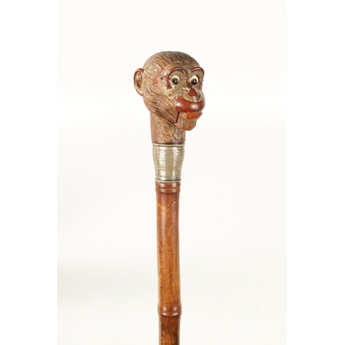 398 - A LATE 19TH NOVELTY WALKING STICK FORMED AS A MONKEY HEAD WITH AUTOMATON EYES AND MOUTH having a sil... 