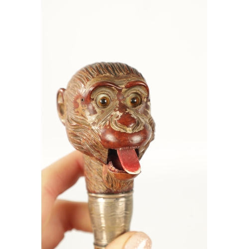 398 - A LATE 19TH NOVELTY WALKING STICK FORMED AS A MONKEY HEAD WITH AUTOMATON EYES AND MOUTH having a sil... 